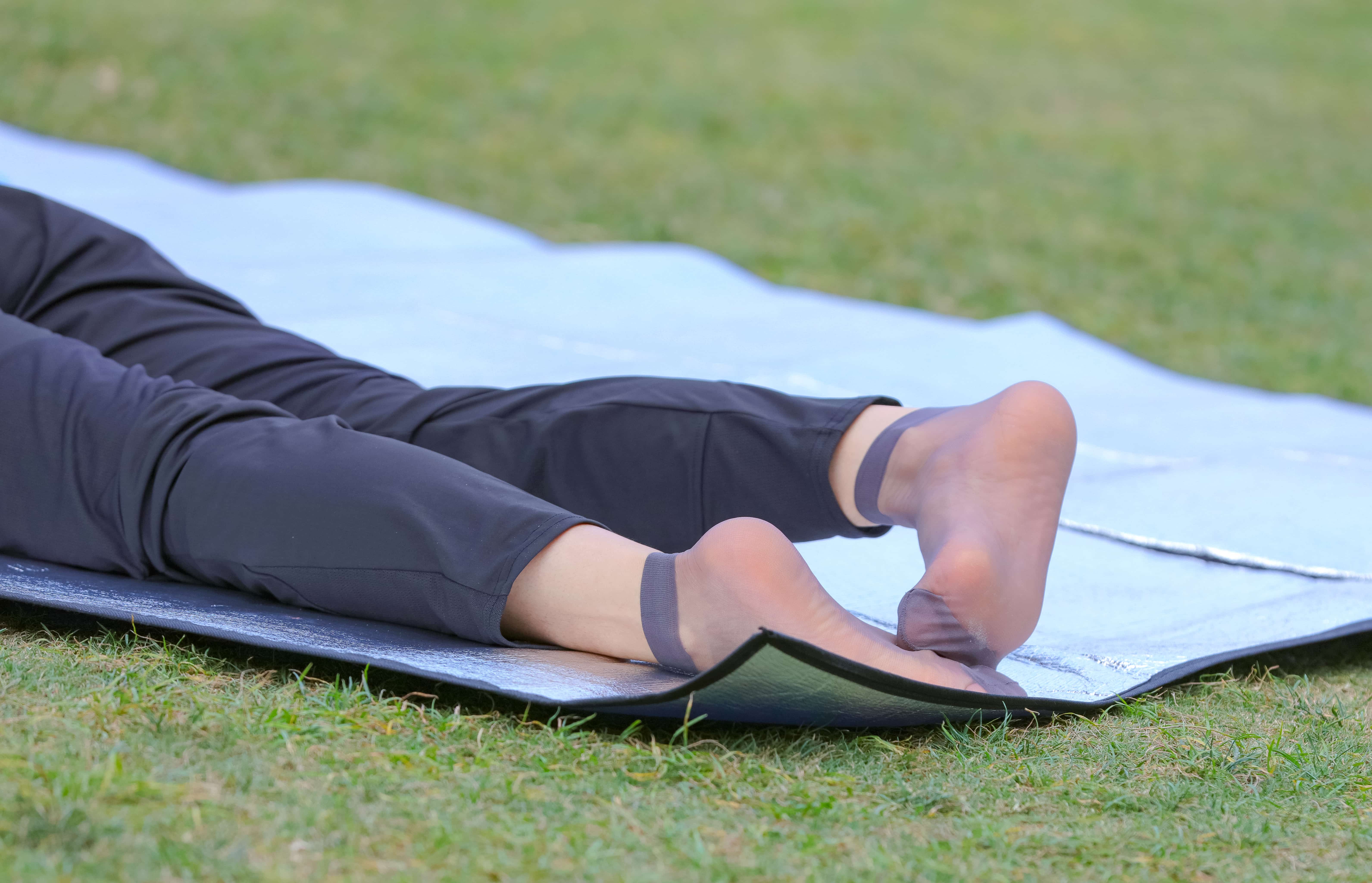 Slim feet flexed in gray nylons